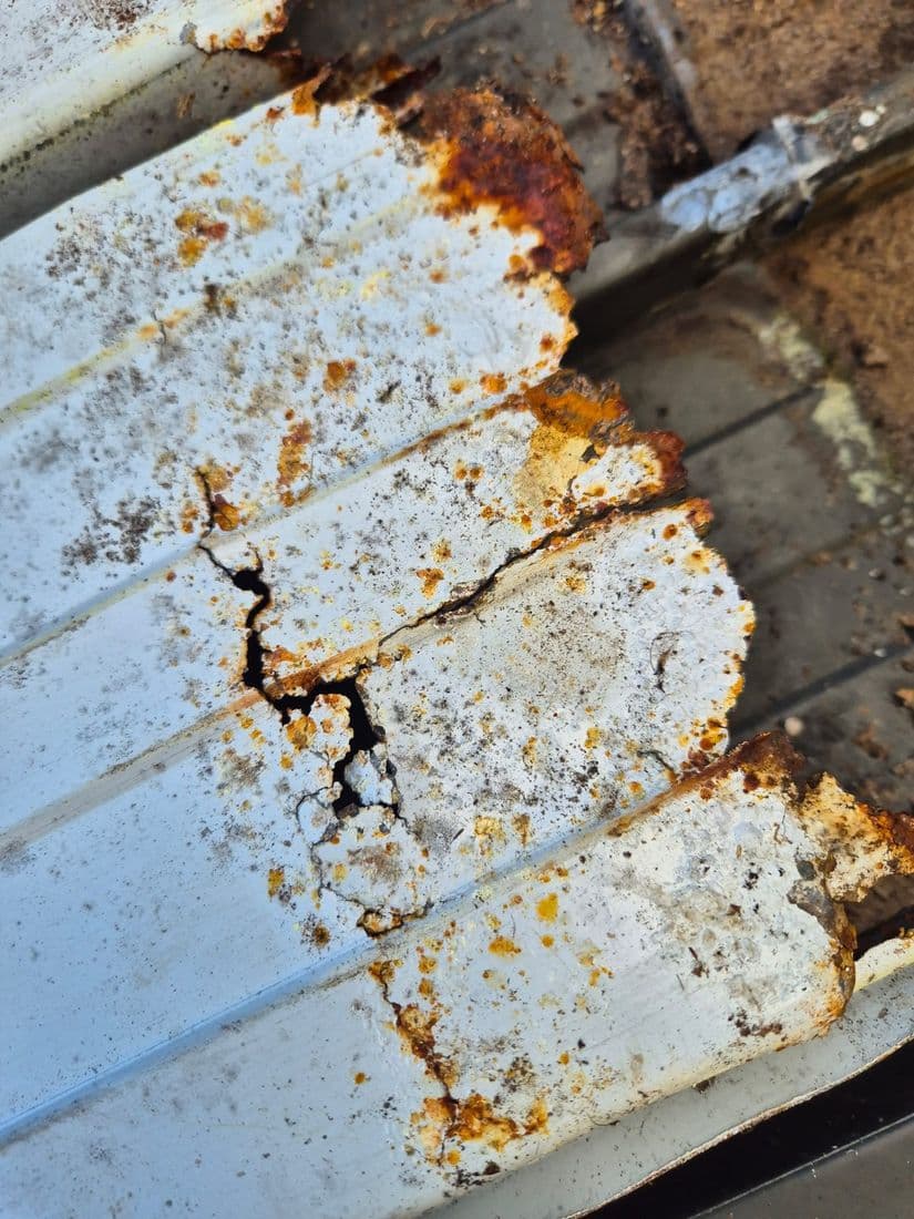 Rusted-through iron before a Whangamata re-roof