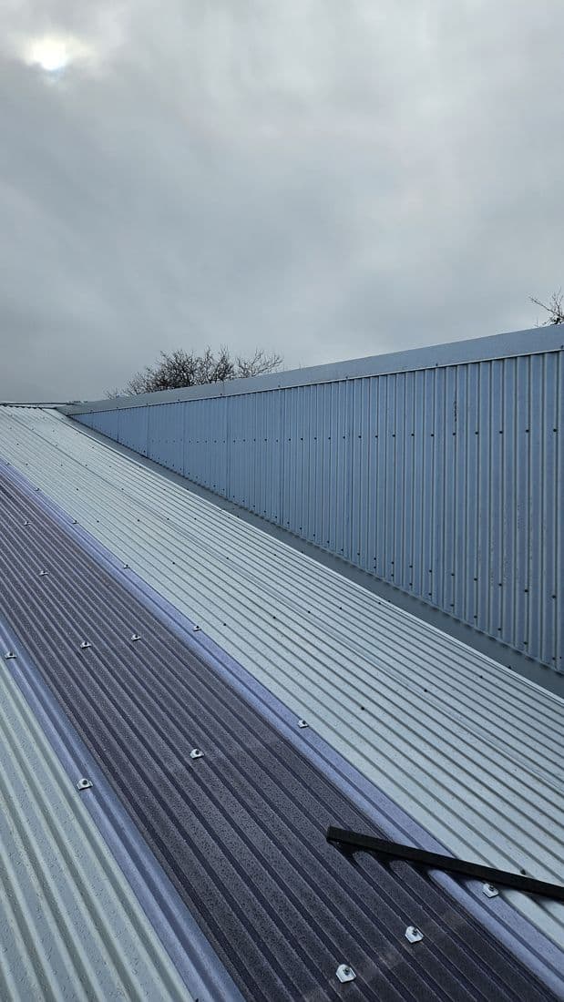 Grey long-run steel roof up close