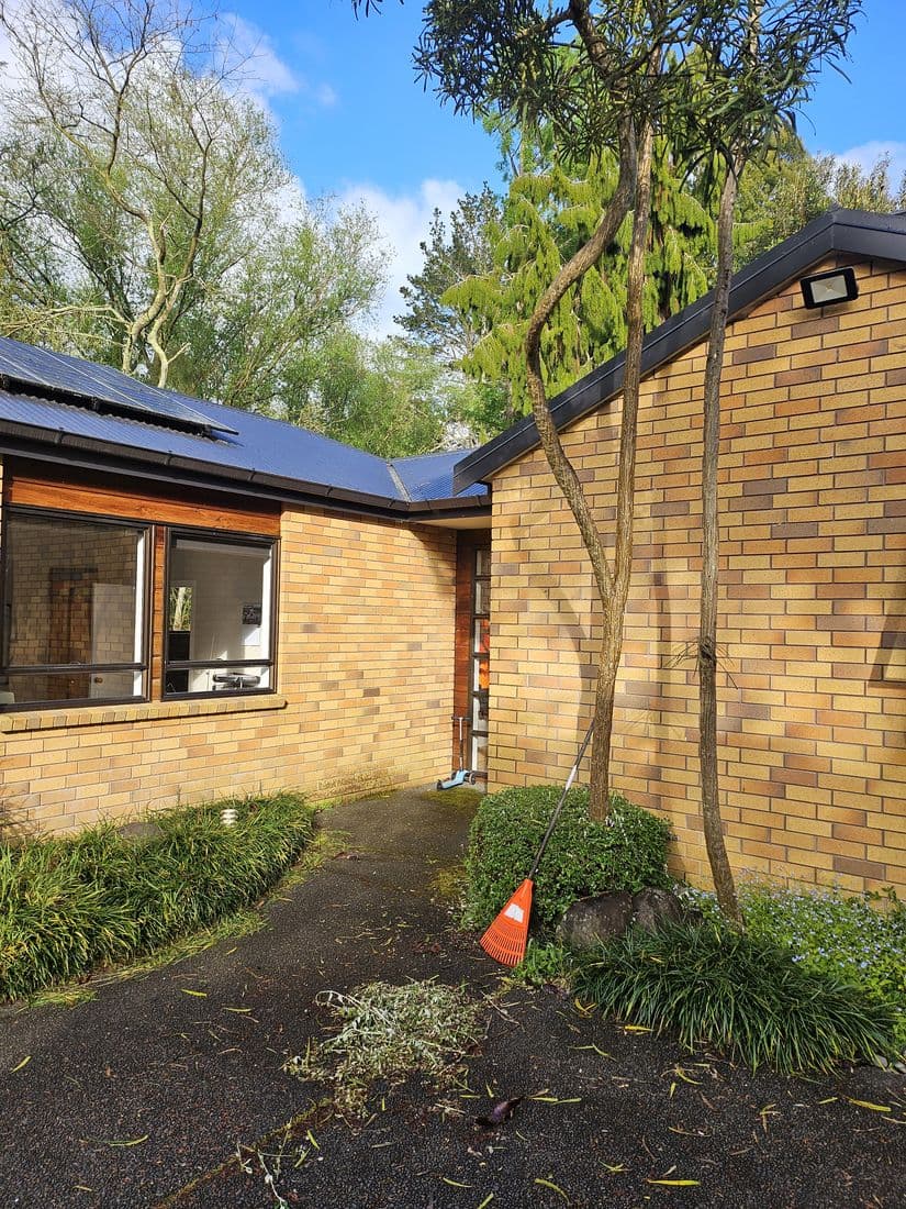 Brick and cedar home with a dark steel roof